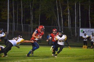 Varsity Football Player from Gwinn going for the tackle