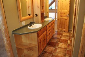 One of the many bathrooms through the house sporting the pine wood theme and dual skin countertop