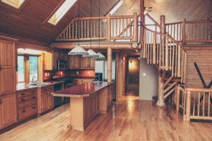 The GORGEOUS main kitchen with top of the line dishwasher, fridge, oven and stove.