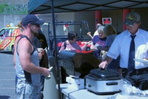 People receiving tasty steak sandwiches