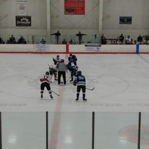 The teams line up at center ice for the faceoff.