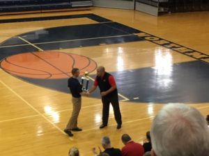 Coach Ben Smith accepts the Championship trophy.