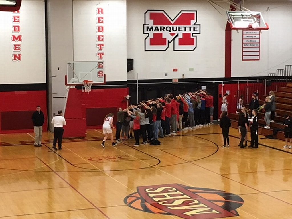 Redette Bridget Pliska goes off the court through a tunnel of fans