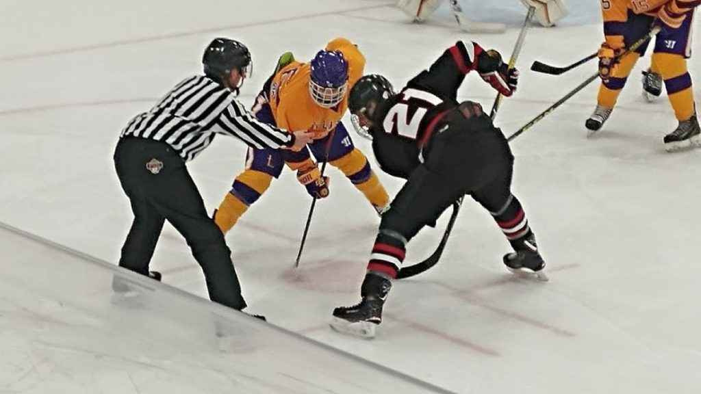Redmen try to win the face off.