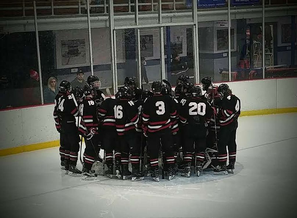 The Marquette Redmen gather around their net and get ready for the game