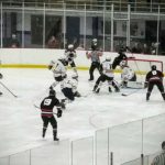 The Marquette Redmen scramble around the Saline net