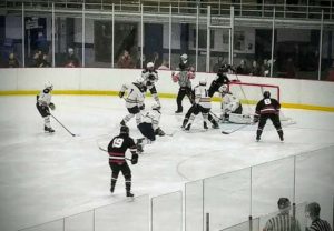 The Marquette Redmen scramble around the Saline net