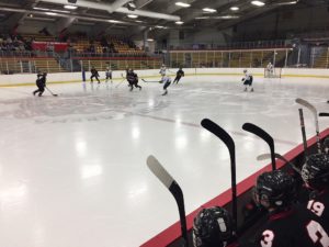 The Redmen with the puck in the neutral zone
