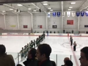 The Traverse City West Titans lined up for the national anthem