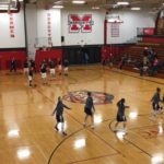 The Marquette Redettes and the Sault Ste. Marie Blue Devils warming up for the game