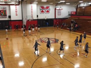 The Marquette Redettes and the Sault Ste. Marie Blue Devils warming up for the game