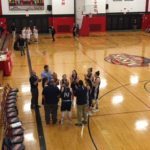 The Blue Devils gather around their coach