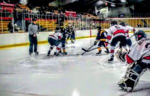 The Redmen get set for a faceoff in their own zone