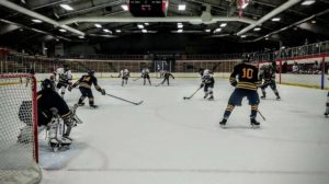 The Marquette Redmen attacking the Negaunee Miners' net