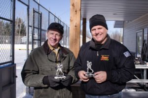 Randy Girard and Todd Noordyk with some of the award trophies for the winning team.