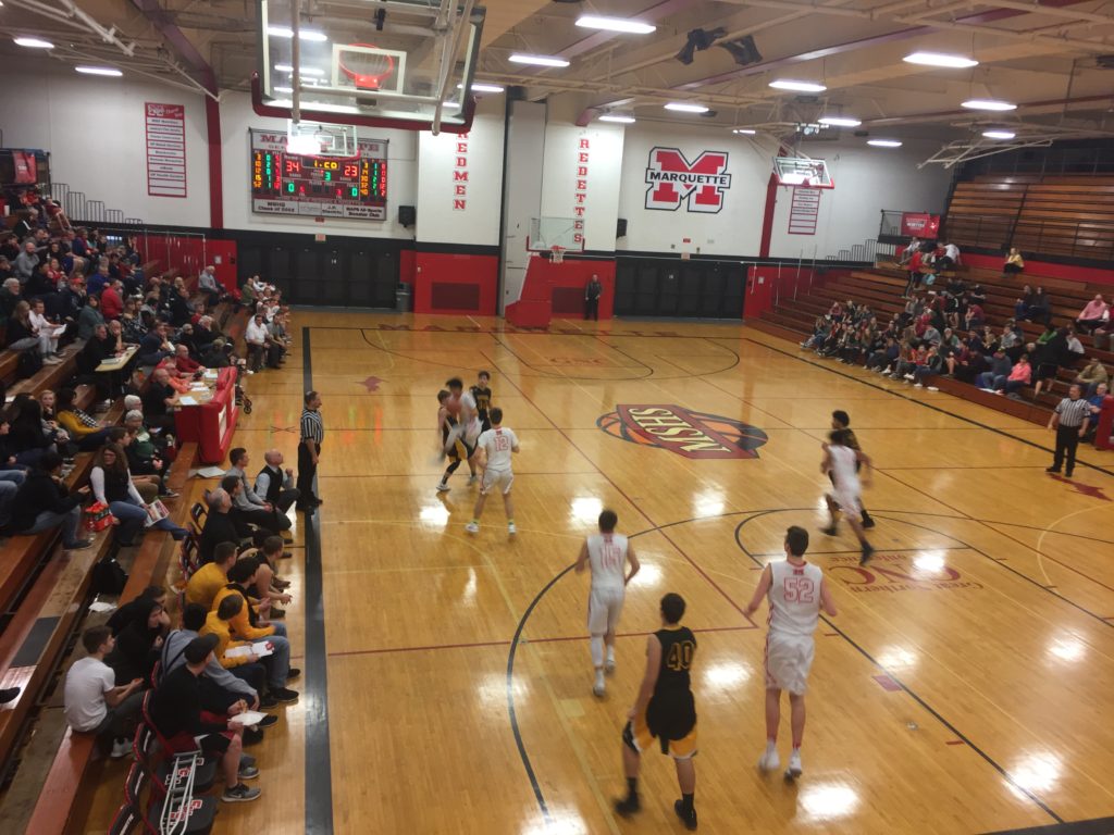 The Marquette Redmen Basketball Team defeats the Gwinn ModelTowners 65-35 on their home turf.
