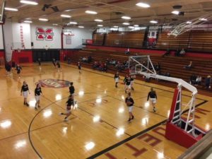 The Marquette Redettes and the Westwood Patriots warming up before the game