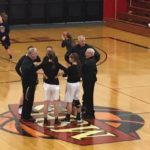 The team captains meet at mid-court