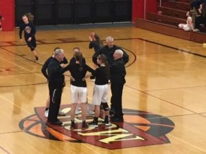 The team captains meet at mid-court
