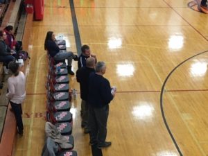 Marquette coach Ben Smith talks with Westwood coach Kurt Corcoran before the game