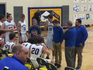 The Flivvers listen to their coach during a time-out