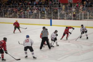 Kevin Rudden from the Negaunee City Fire Department picking up the puck.