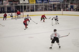 Brent Burke from the Ishpeming City Fire Department moving the puck out of the Heat's zone.