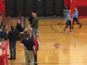 Marquette coach Ben Smith talks with Petoskey coach Bryan Shaw before the game