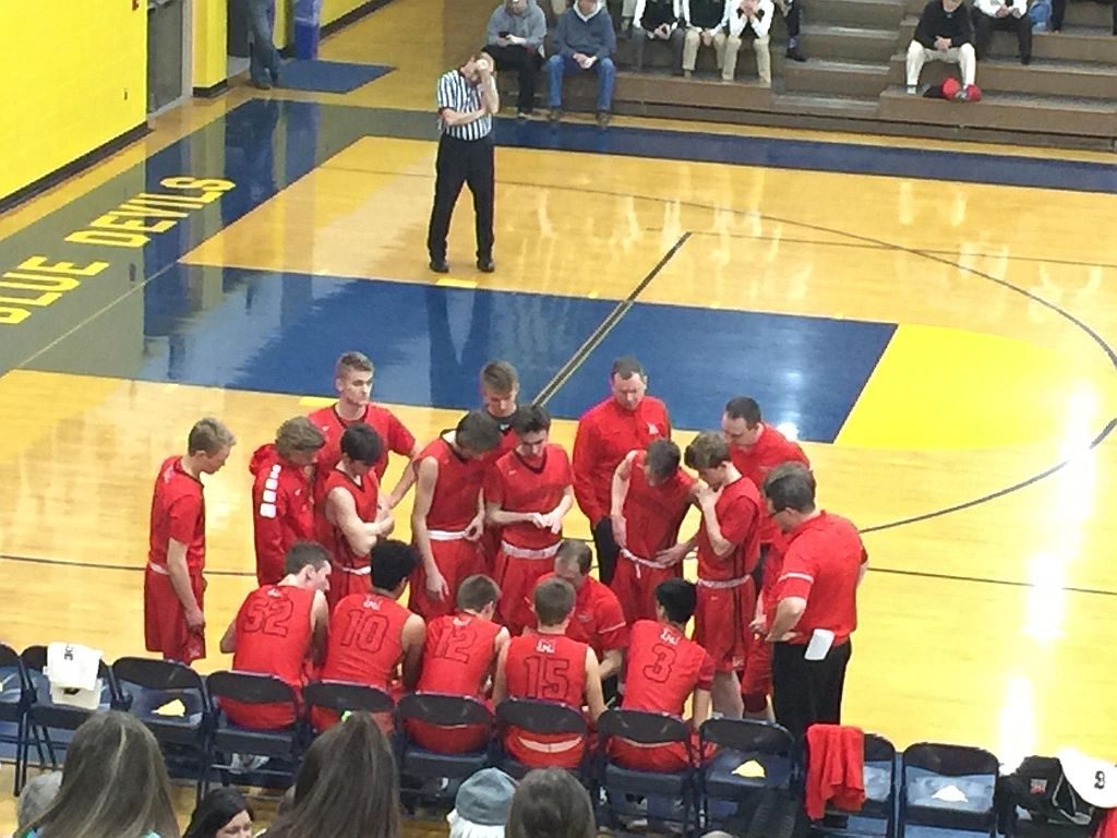Marquette coach Brad Nelson talking to his team before the opening tip