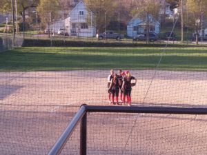 The infielders for Marquette have a conference with the pitcher