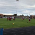 Marquette football warms up before taking on the Kingsford Flivvers.