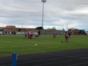 Marquette football warms up before taking on the Kingsford Flivvers.