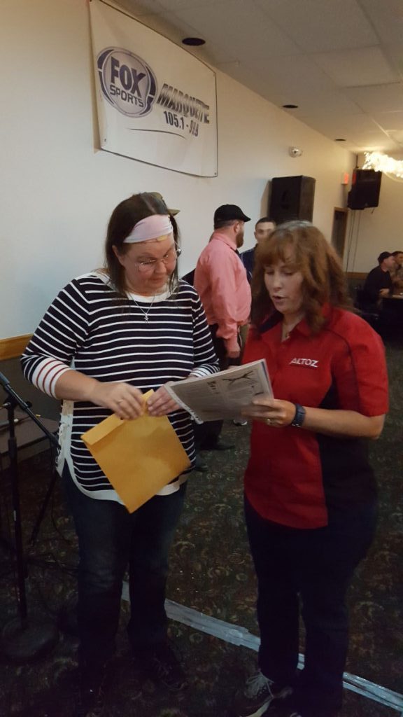 Tracy Frossard presents Elizabeth Hollowell with the grand prize.