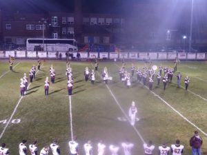 The Maroons' marching band entertains the crowd during half time.