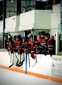 The Redmen cheer on their teammates.