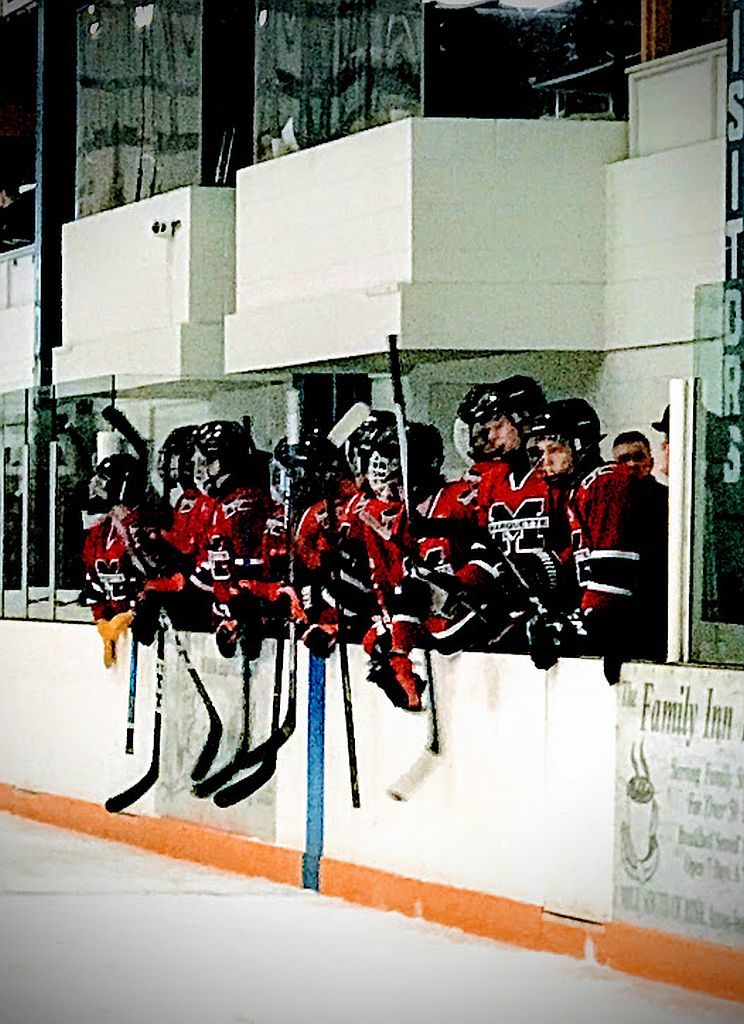 The Redmen cheer on their teammates.
