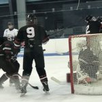 Evan Kroll helps protect the Redmen goal.