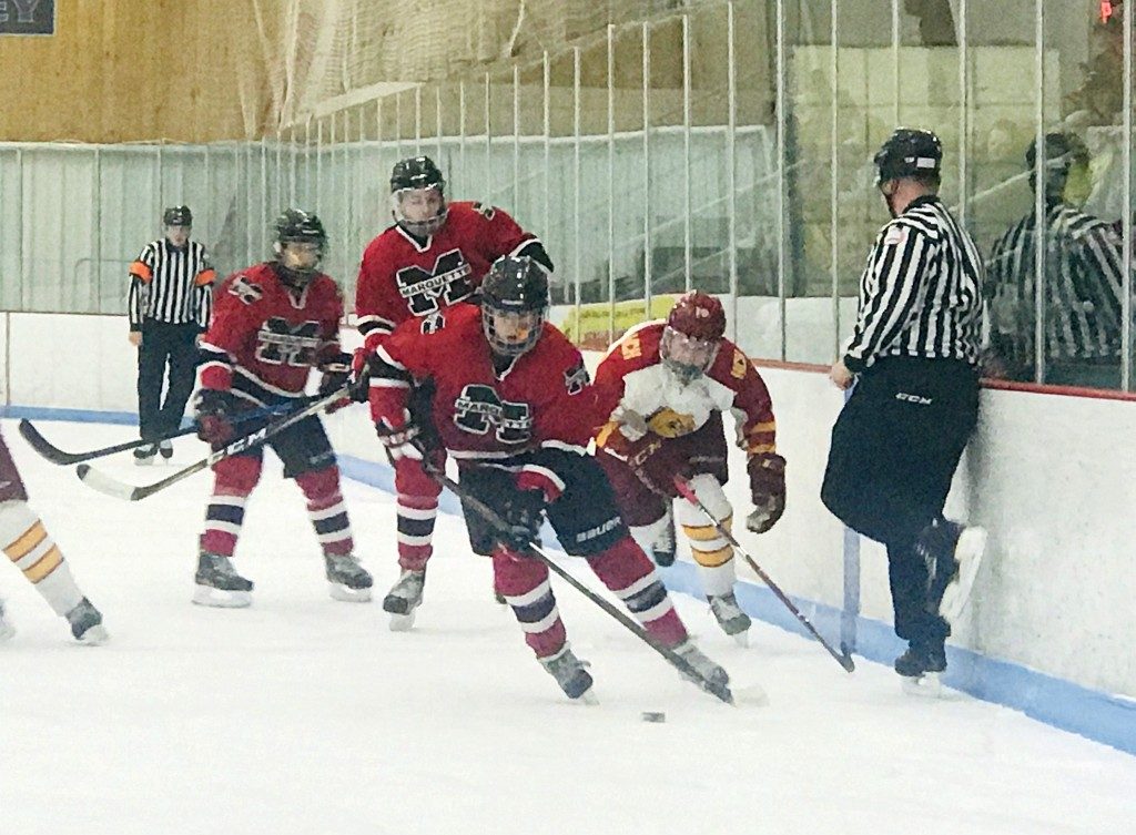 Marquette skates the puck down the ice.
