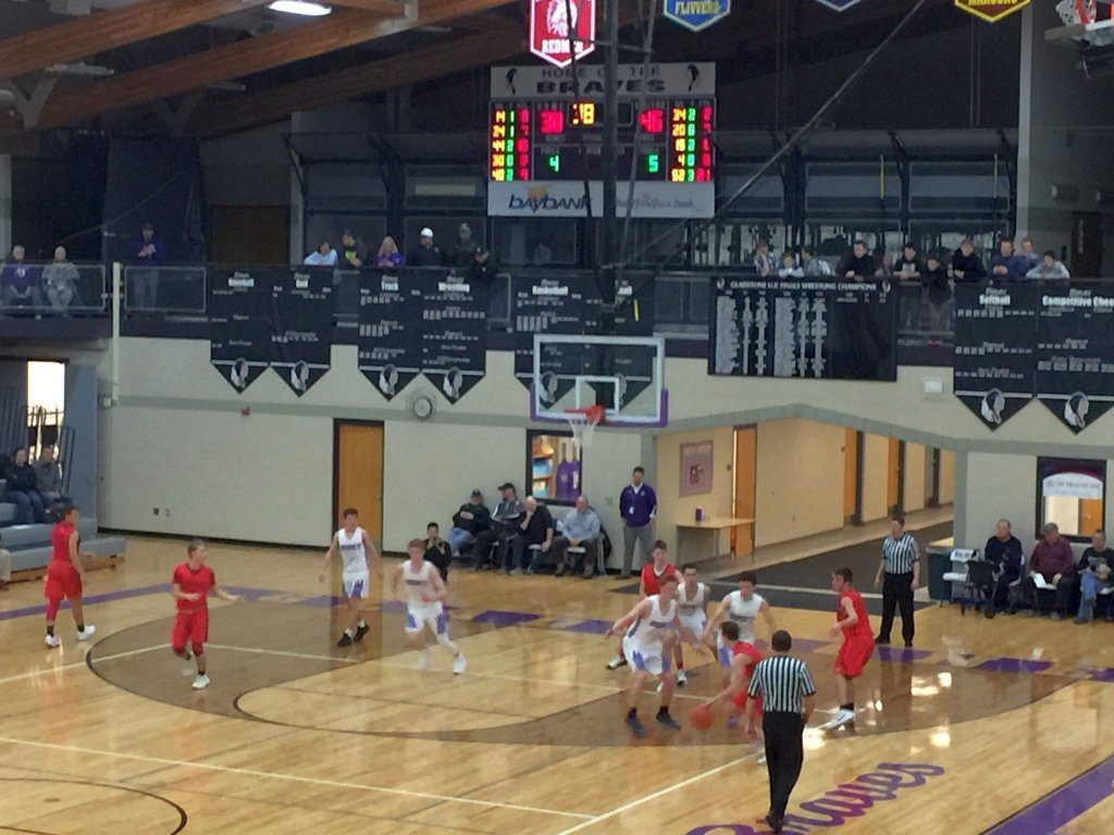 The Marquette Redmen boys basketball team attempts to drive to the basket against the Gladstone Braves on December 11th, 2018