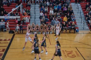 Putting up a shot on the basket.