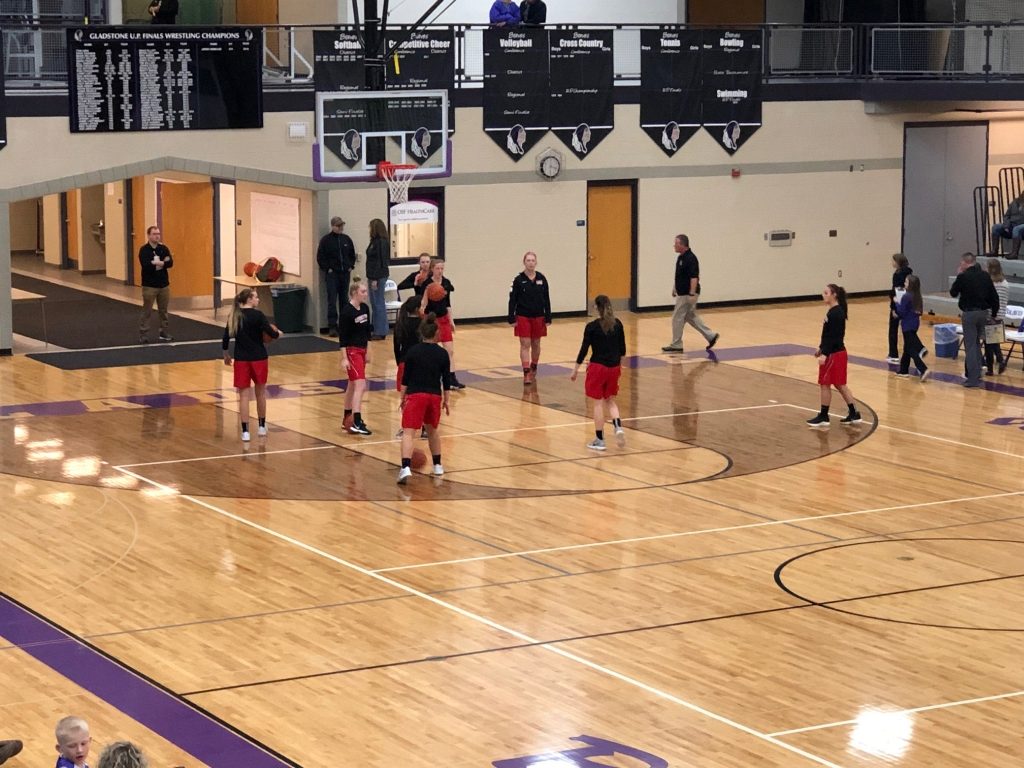 The Marquette Girls Varsity Basketball Team warming up on the Gladstone court.
