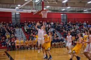 The Redmen control to hold the lead against the Negaunee Miners.