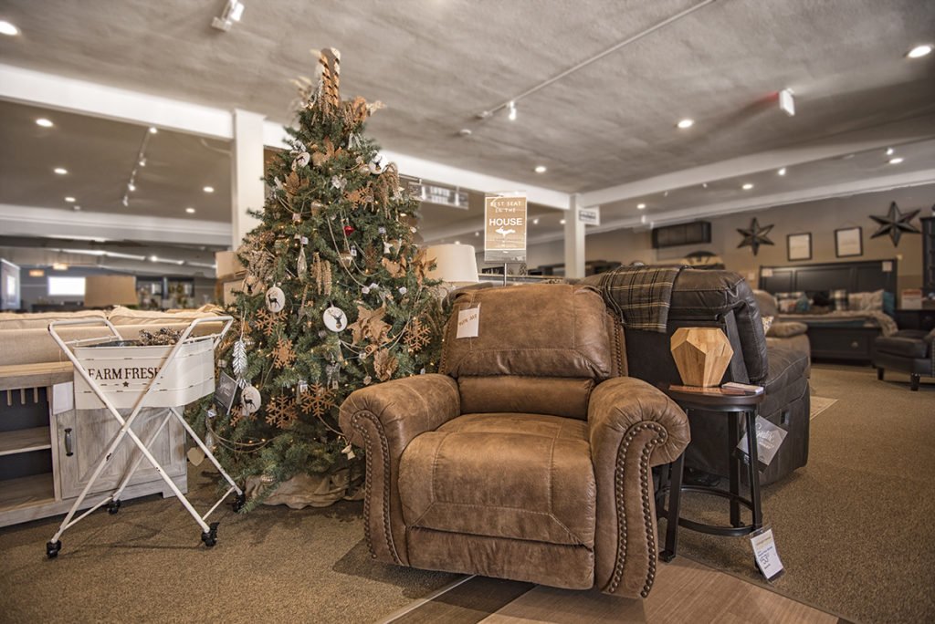 The Best Seat in the House display is located directly behind the service desk in Ashley HomeStore.
