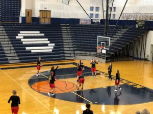 The Redettes warm up for their game against the Brighton Bulldogs.