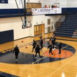 The Brighton Bulldogs warm up as the home team at the Petoskey Invitational game opener against our Marquette Redettes.