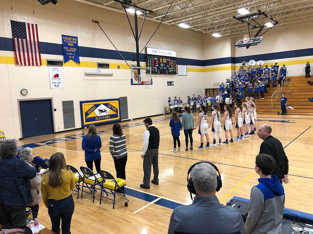 The Redettes stand for the national anthem.