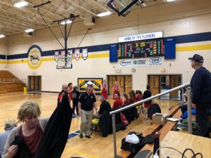 A fan photo-bombs the Redettes bench.