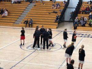 The Marquette Redettes' captains head to center court to do the coin flip against Calumet Copper Kings