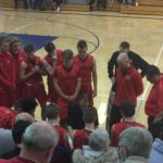 The Redmen huddle during a time out.