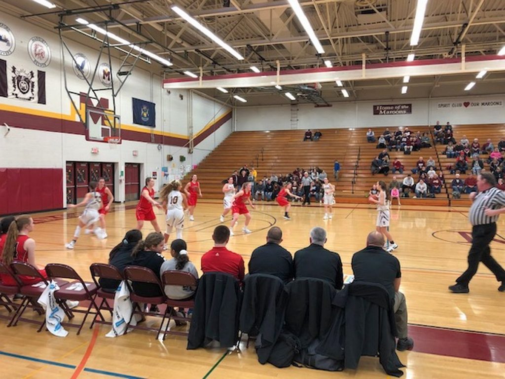 Action from behind the Marquette Redettes' bench during their game against the Menominee Maroons on 97.5 GTO-FM